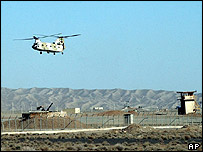 Iranian helicopter flies over an anti-aircraft gun at the Natanz facility