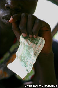 Young girl holding a 1,000 Sudanese dinar note (2.50; $4.80) 