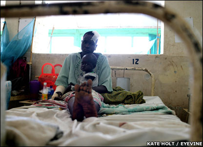 A woman sits with her baby in the Juba Teaching Hospital 