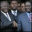 In this Jan. 24, 2008 file picture Kenyan President Mwai Kibaki, left, shake hands with opposition leader Raila Odinga, right, in Nairobi, Kenya.