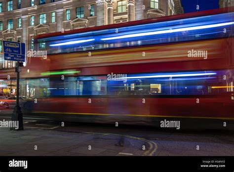 Passing Double decker bus on the streets of London by night Stock Photo ...