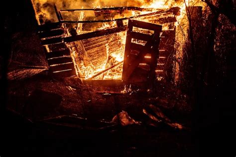 Premium Photo | Firefighters and a burning house burn with flames