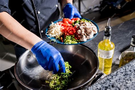 Premium Photo | Chef cooking pasta with vegetables in pan. Italian ...