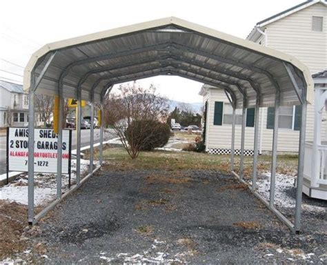 a covered parking lot in front of a white house