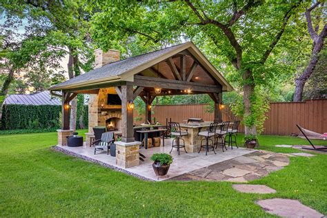 This freestanding covered patio with an outdoor kitchen and fireplace ...