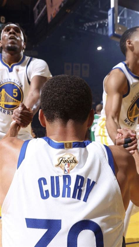 two basketball players are sitting on the court