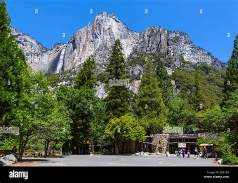 Visitor Center at Yosemite Village with Yosemite Falls in distance ...