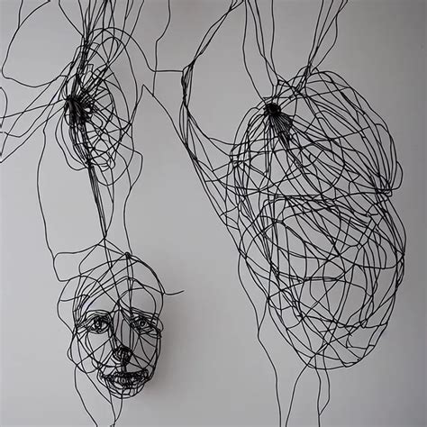 elegantly hanging wire art sculpture of a human face | Stable Diffusion