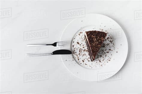 Top view of chocolate cake with glaze on plate - Stock Photo - Dissolve