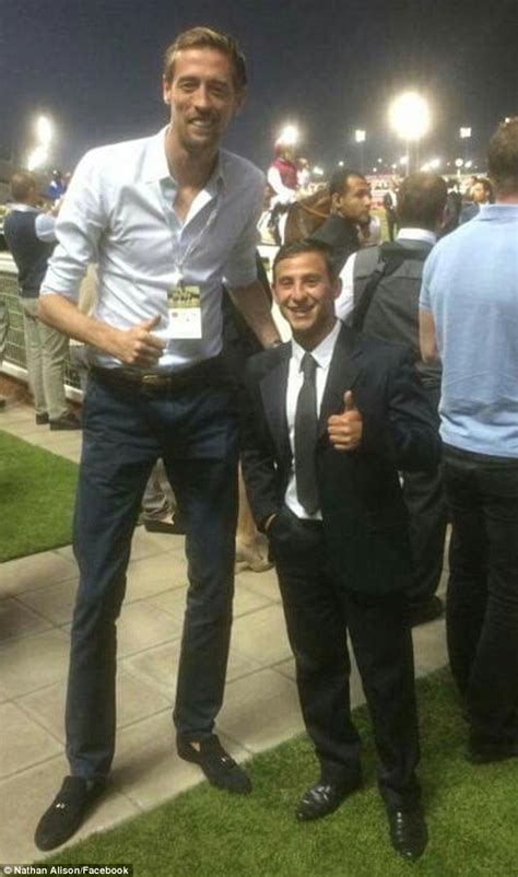 That's a tall order! Peter Crouch stops for a picture with diminutive ...