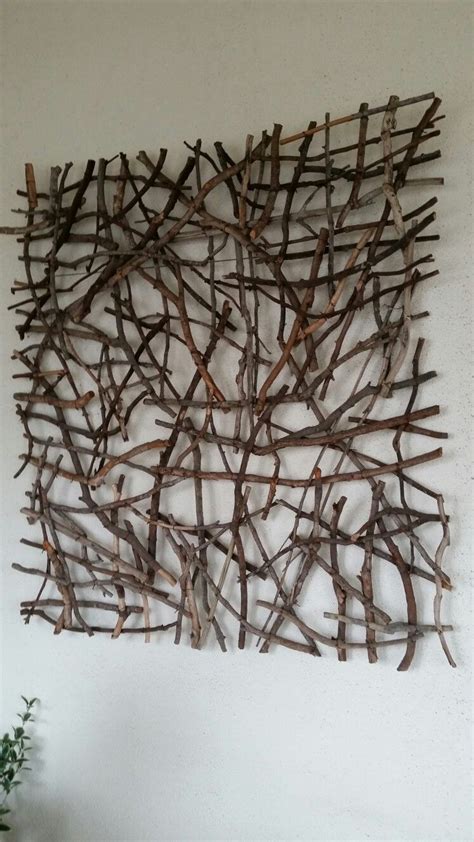 Stick wall hanging. Sticks randomly crossed secured with twisted wire ...