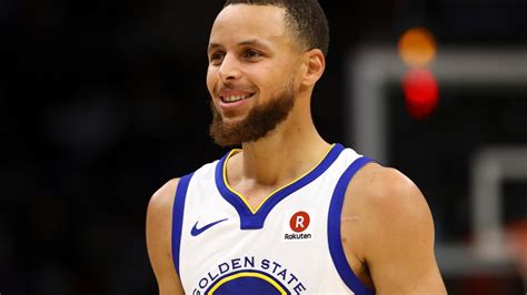 Stephen Curry poses with the haircut version of himself in China