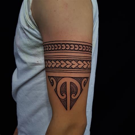 Maōri tattoo arm bands with a traditional Ta Moko triangle done ...