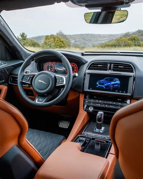 the interior of a car with brown leather seats and dashboard controls ...