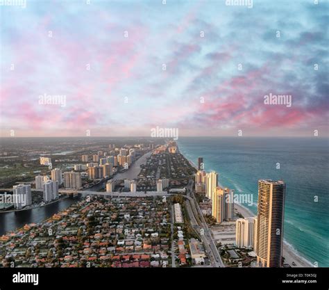 Aerial view of Miami Beach at sunset from helicopter. City skyline and ...