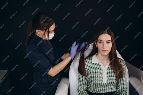 Premium Photo | Doctor trichologist examines woman patient's hairs ...