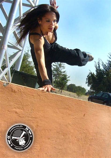 a woman doing a trick on a skateboard in front of a ramp and stairs