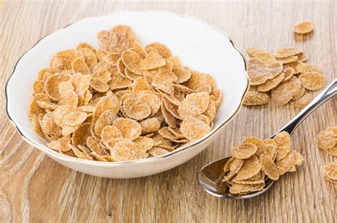 Multi Cereal Flakes in Bowl, Spoon with Flakes, on Table Stock Image ...