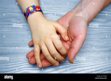 Autism Awareness Picture. Father holding hand his autistic child Stock ...