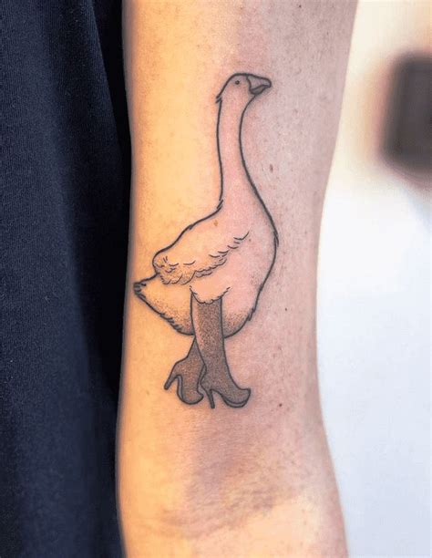 a small goose tattoo on the arm