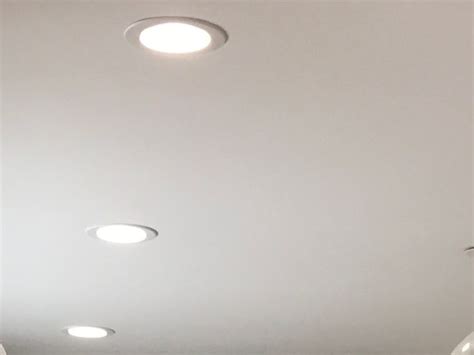 the ceiling is white and has four round lights