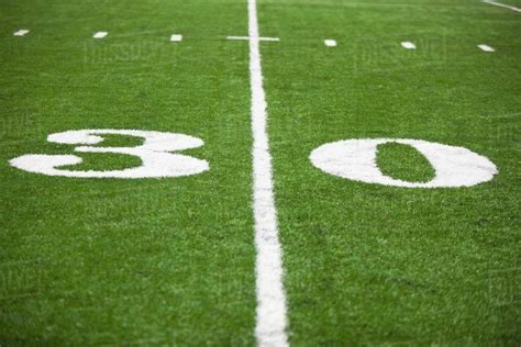 The 30 Yard Line Marked On A Football Field - Stock Photo - Dissolve