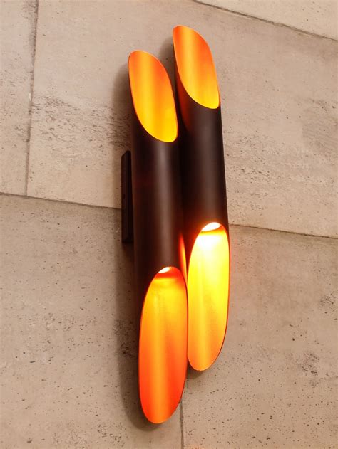 Retro wall light with multi up and down cones with a black outer and ...