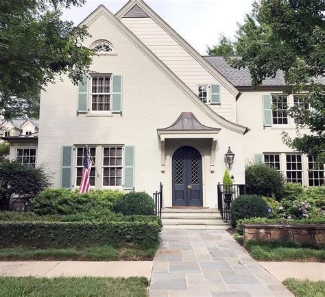 A look at a classic 2 story French Provincial inspired house with white ...