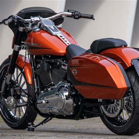 an orange motorcycle parked in front of a building