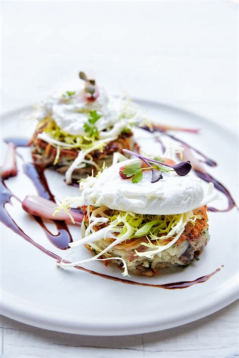 "Crispy Duck Confit Hash Frisee Salad With Poached Egg" by Stocksy ...