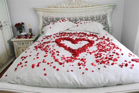 Bed with Real Red Rose Petals Stock Photo - Image of kingsize, candles ...