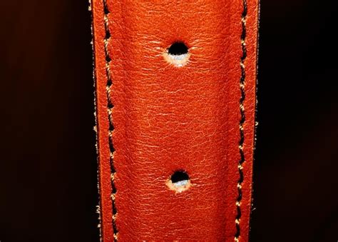 Premium Photo | A brown leather strap with holes in it.