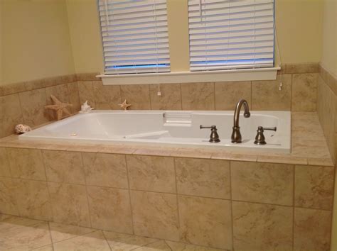 Deep jetted tub with tile surround.