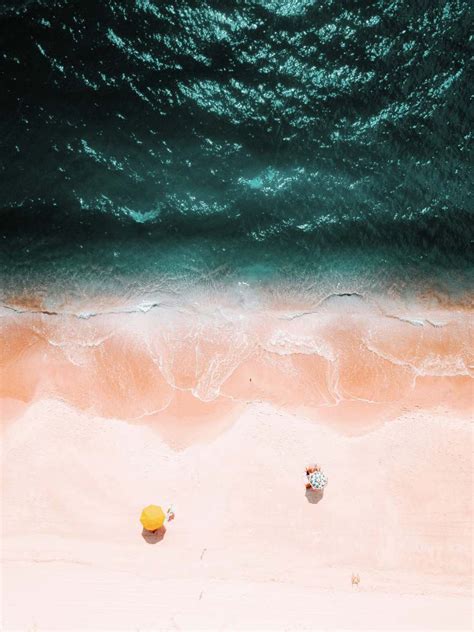 Beach Bird's Eye View Of Two Yellow And Green Umbrellas On Beach Naples ...