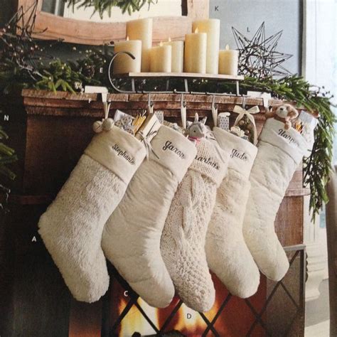 pottery barn white stockings with candles and greenery and star *mantle