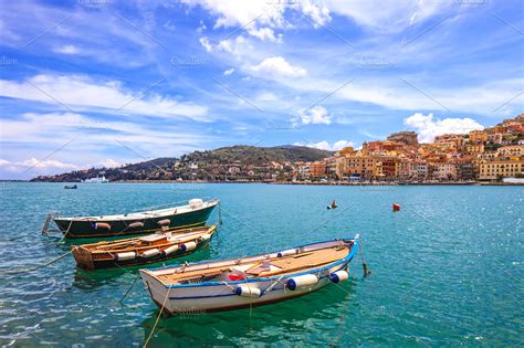 Wooden boats in porto santo stefano containing background, beach, and ...