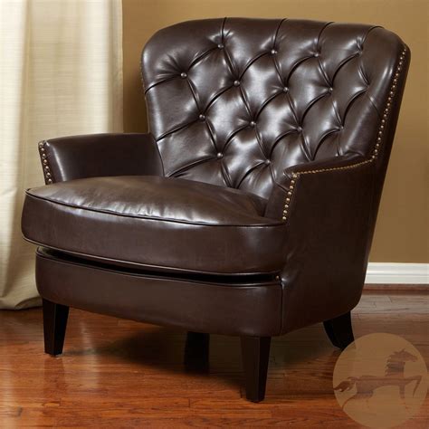 With deeply tufted back and studded perimeter, this club chair features ...