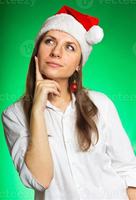 Cheerful girl in a Christmas hat 21094457 Stock Photo at Vecteezy