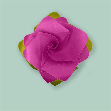 Premium Photo | Pink purple paper origami handmade rose on blue