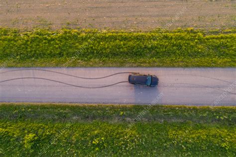 Aerial view of car driving on road by fields, Vatla, Estonia - Stock ...