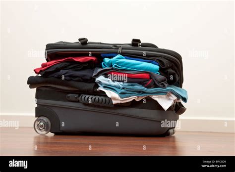 Suitcase stuffed with way to much clothes Stock Photo - Alamy