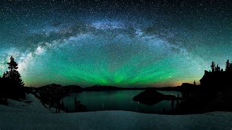 Aurora borealis and the milky way above a lake, stars, northern lights ...