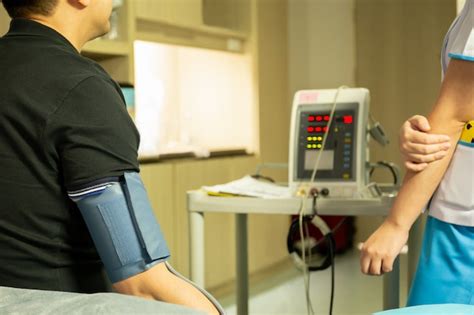 Premium Photo | Nurse checking blood pressure on monitor screen for ...