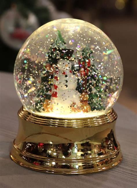 Snowmen figurines inside swirling glitter water globes, no need to ...