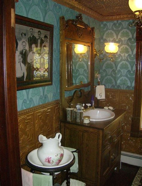 Victorian Bathroom with Blue Wallpaper and Wooden Cabinets