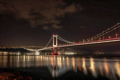 Premium Photo | The bosphorus bridge at night with lights shining over ...