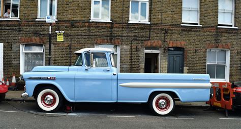 ’59 Chevy pickup undergoing restoration, right on a street in London