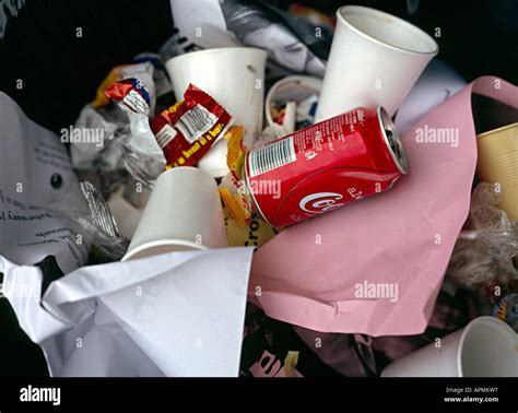 waste in a bin with a coke can on top Stock Photo - Alamy