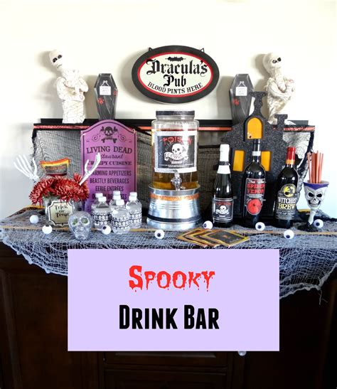 spooky drink bar with halloween decorations on the top and purple sign ...