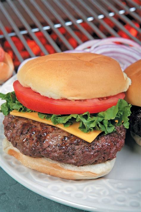 Freshly Grilled Cheeseburger on Plate by Grill - Prepared Food Photos, Inc.